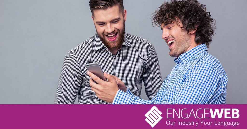 Guys laughing at joke on phone