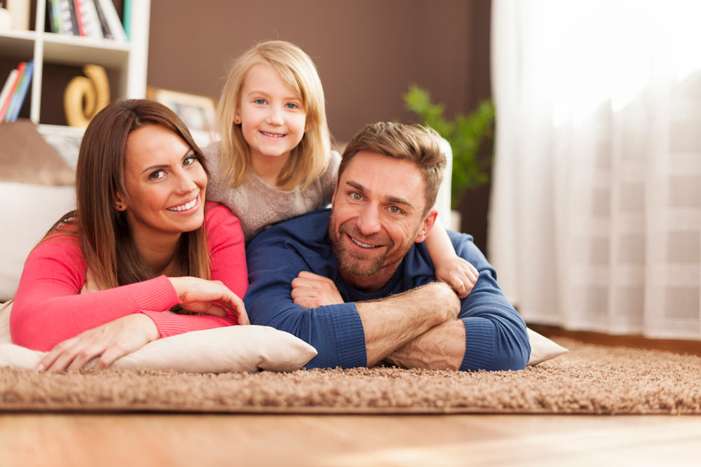portrait of loving family on carpet SBI 328444927
