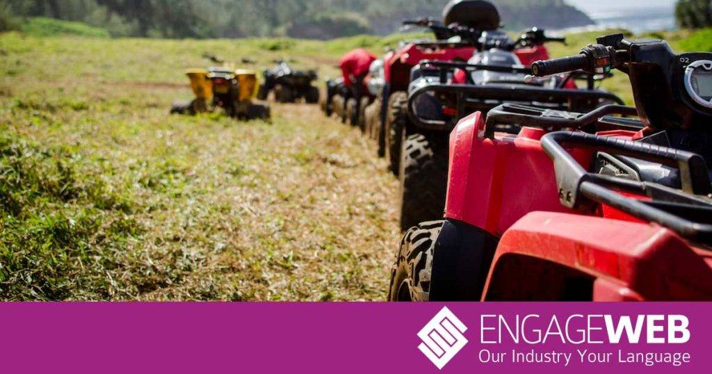 A row of red quad bikes in a field